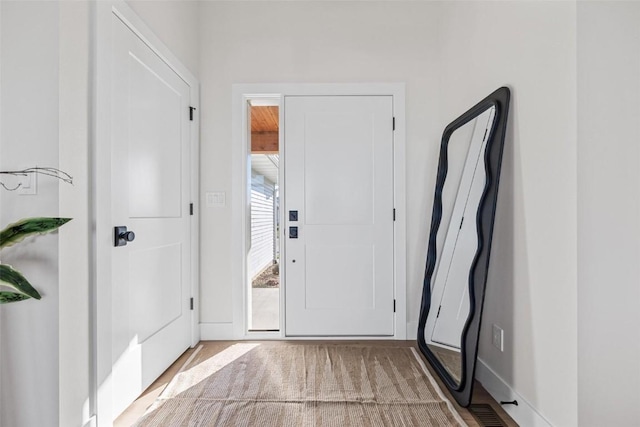 view of carpeted foyer entrance