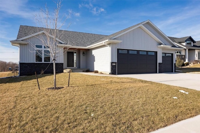 view of front of home with a front yard and a garage