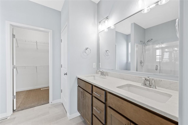 bathroom featuring vanity and a shower with shower door