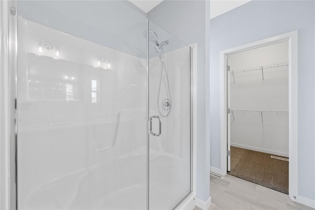 bathroom featuring a shower with door