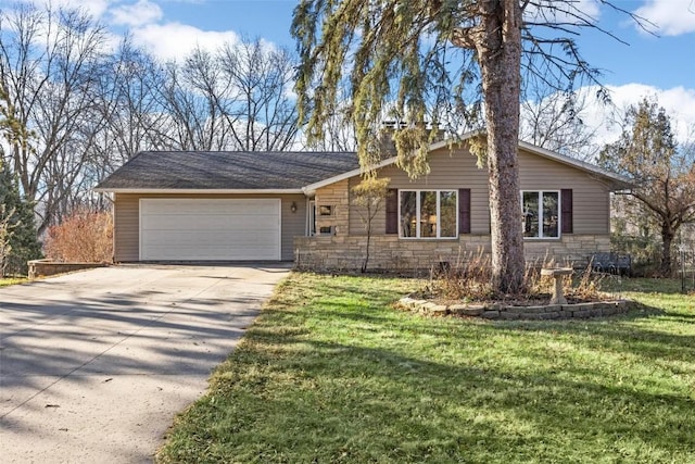 view of front facade featuring a front yard, stone siding, driveway, and an attached garage