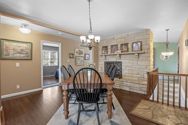 dining room featuring an inviting chandelier, wood finished floors, and baseboards