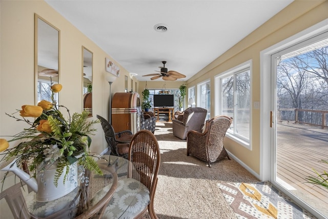 sunroom featuring visible vents and a ceiling fan