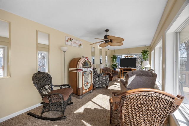 sunroom featuring a ceiling fan