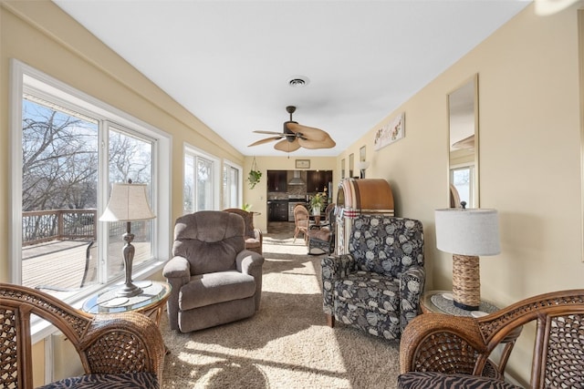 sunroom / solarium with a fireplace, visible vents, and a ceiling fan