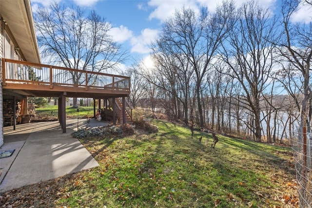 view of yard with a patio area, stairway, and a wooden deck