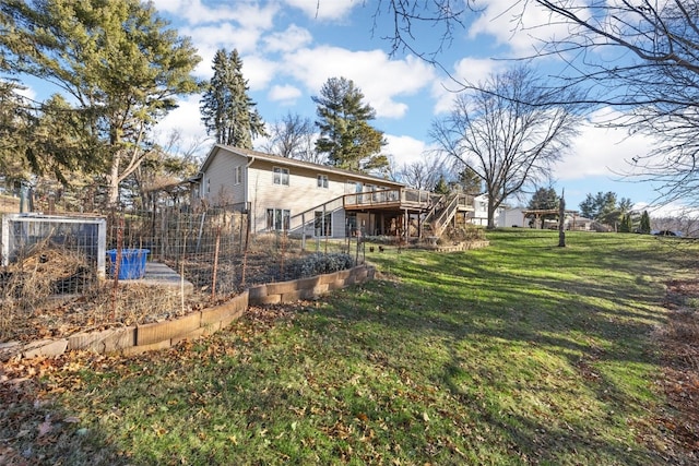 view of yard with a deck, stairway, and a garden