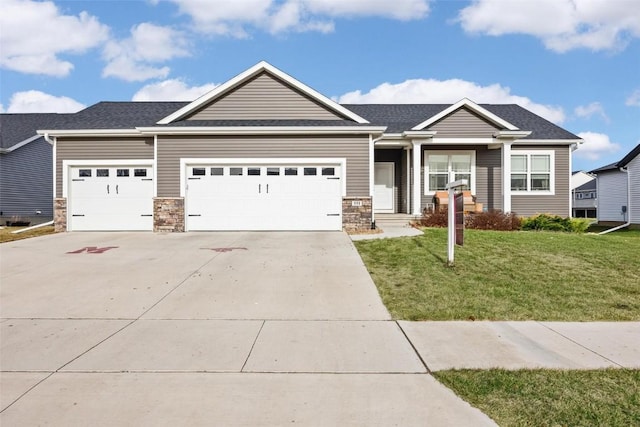 craftsman house with a garage and a front lawn