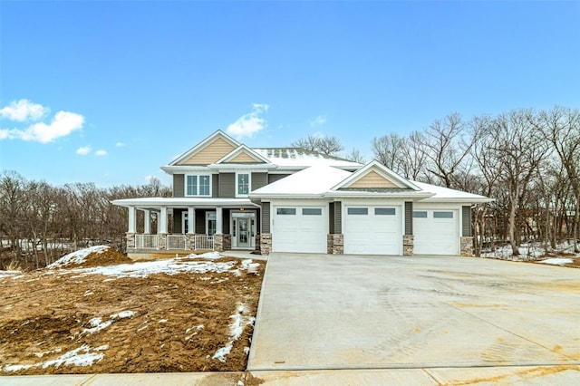 craftsman inspired home with covered porch and a garage