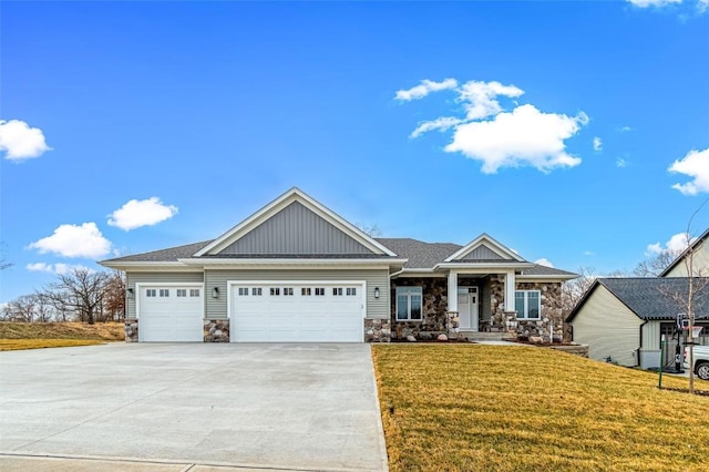 craftsman-style house with a garage and a front lawn