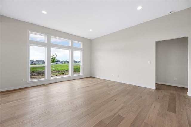 spare room with light hardwood / wood-style floors