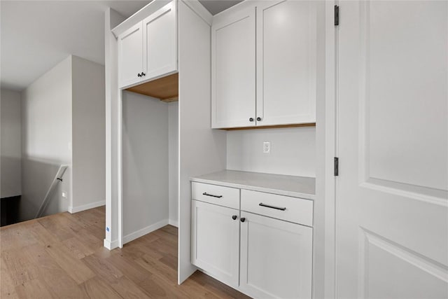 kitchen with white cabinets and light hardwood / wood-style flooring