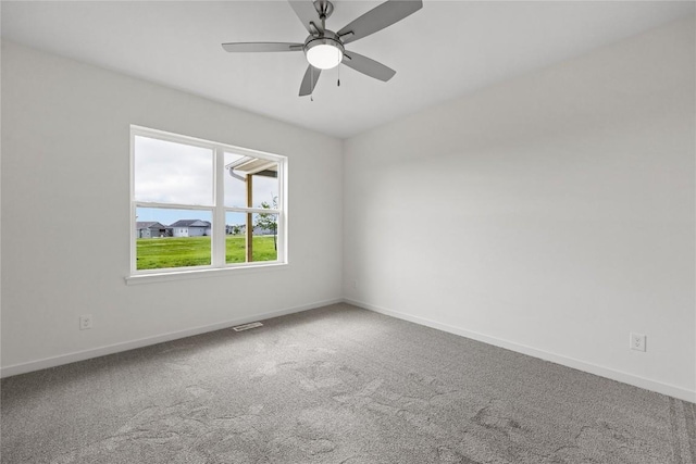 unfurnished room featuring ceiling fan and carpet floors