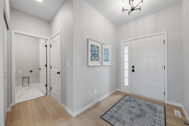334 Quiver Ct, Marion, IA 52302 - entrance foyer with light wood finished floors, a chandelier, and baseboards