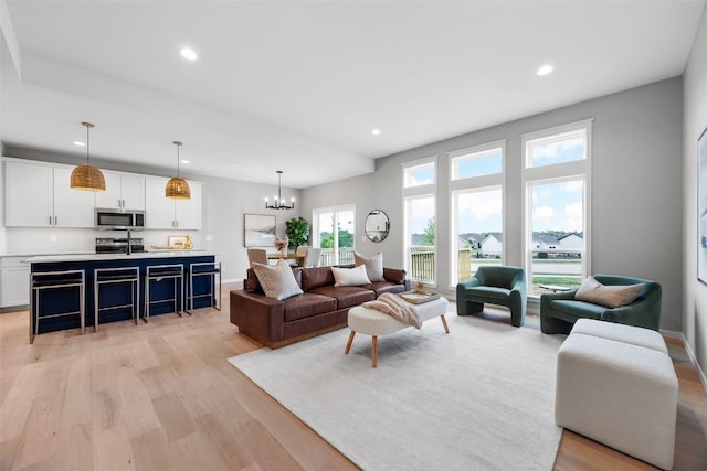 334 Quiver Ct, Marion, IA 52302 - living room featuring light wood finished floors, a chandelier, recessed lighting, and baseboards