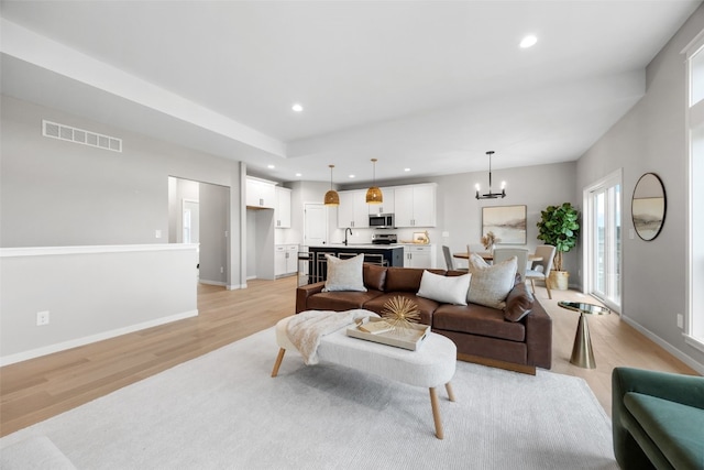 334 Quiver Ct, Marion, IA 52302 - living room with light wood-style floors, a chandelier, recessed lighting, and baseboards