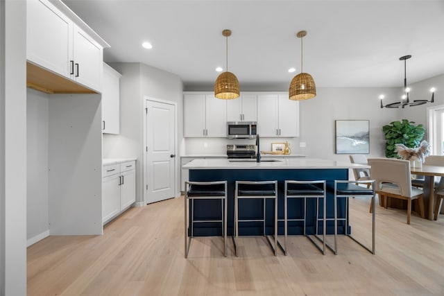 334 Quiver Ct, Marion, IA 52302 - kitchen featuring appliances with stainless steel finishes, light wood-style floors, light countertops, white cabinetry, and recessed lighting