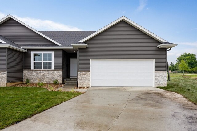 334 Quiver Ct, Marion, IA 52302 - view of front facade featuring stone siding, concrete driveway, a front yard, roof with shingles, and an attached garage