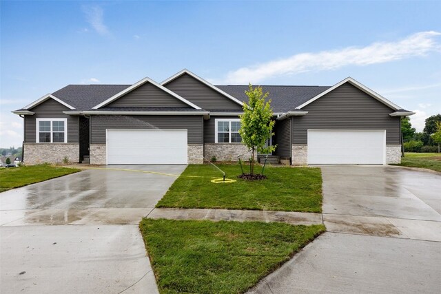 334 Quiver Ct, Marion, IA 52302 - view of front of property featuring driveway, an attached garage, a front lawn, and stone siding