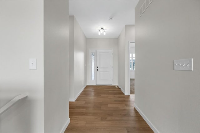 hallway with hardwood / wood-style flooring