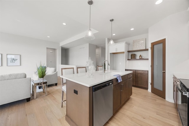 332 Quiver Ct, Marion, IA 52302 - kitchen with stainless steel dishwasher, light wood-style floors, a breakfast bar area, open floor plan, and recessed lighting