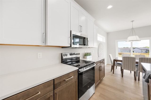 332 Quiver Ct, Marion, IA 52302 - kitchen featuring stainless steel appliances, light countertops, light wood-style flooring, white cabinetry, and recessed lighting