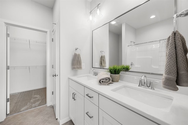 332 Quiver Ct, Marion, IA 52302 - full bath with double vanity, a shower, a walk in closet, and recessed lighting