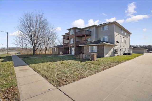 exterior space with a lawn, a balcony, and a garage