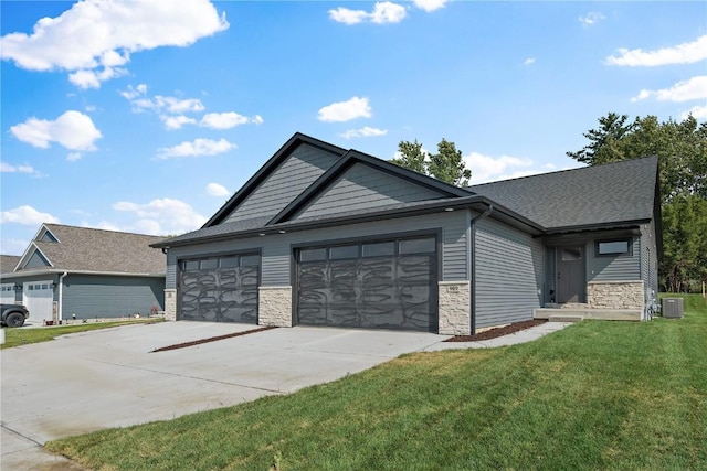 view of front of home with an attached garage, stone siding, driveway, and a front yard