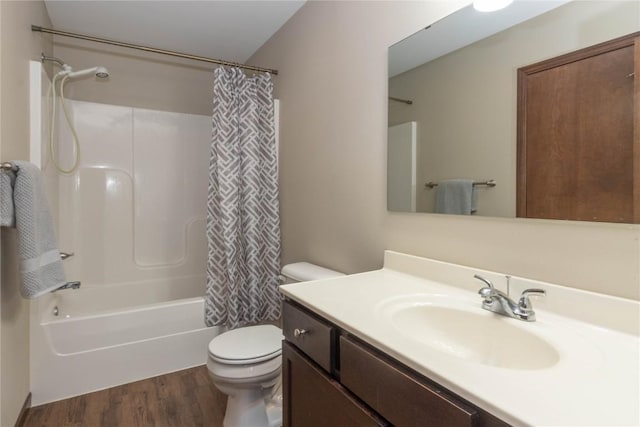 full bathroom with wood-type flooring, vanity, shower / tub combo, and toilet