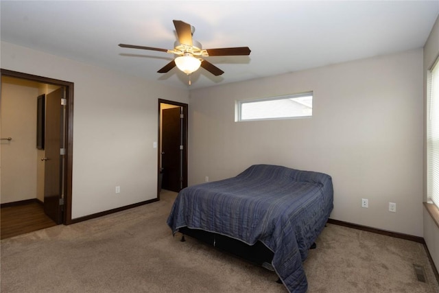 bedroom featuring ceiling fan and light carpet