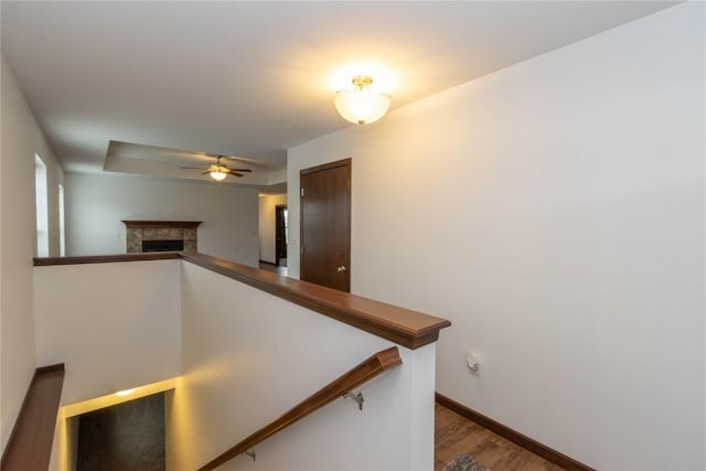 stairway with hardwood / wood-style flooring and ceiling fan