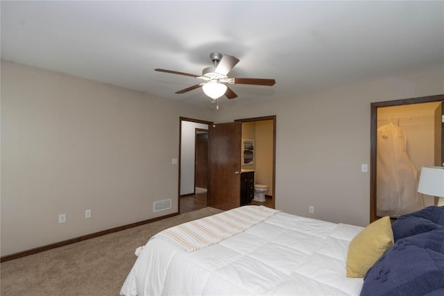 1135 Redbud Ave, Tiffin, IA 52340 - carpeted bedroom featuring baseboards, a walk in closet, connected bathroom, a ceiling fan, and a closet