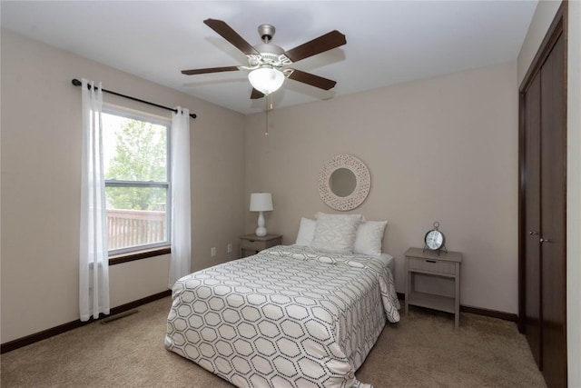 1135 Redbud Ave, Tiffin, IA 52340 - bedroom featuring light colored carpet, baseboards, a closet, and a ceiling fan