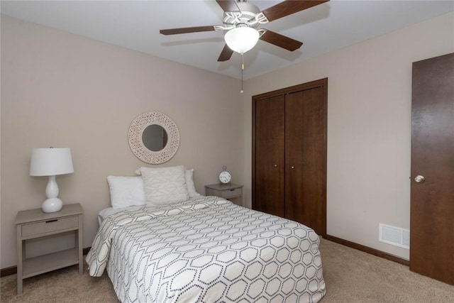 1135 Redbud Ave, Tiffin, IA 52340 - bedroom featuring light colored carpet, a closet, baseboards, and ceiling fan