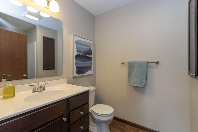 1135 Redbud Ave, Tiffin, IA 52340 - bathroom with toilet, vanity, and wood finished floors