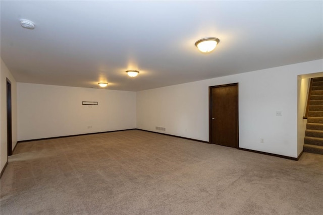 1135 Redbud Ave, Tiffin, IA 52340 - unfurnished room featuring light carpet, a smoke detector, stairway, and baseboards