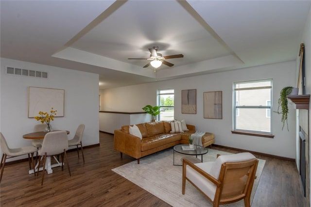 1135 Redbud Ave, Tiffin, IA 52340 - living area with a tray ceiling, ceiling fan, baseboards, and wood finished floors