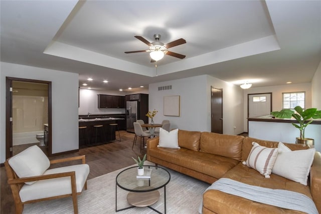 1135 Redbud Ave, Tiffin, IA 52340 - living area with a raised ceiling, ceiling fan, wood finished floors, and recessed lighting