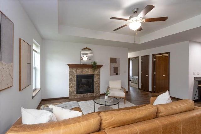 1135 Redbud Ave, Tiffin, IA 52340 - living room with a ceiling fan, a high end fireplace, wood finished floors, and baseboards