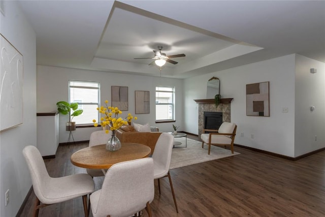 1135 Redbud Ave, Tiffin, IA 52340 - dining space featuring a tray ceiling, a ceiling fan, baseboards, and wood finished floors
