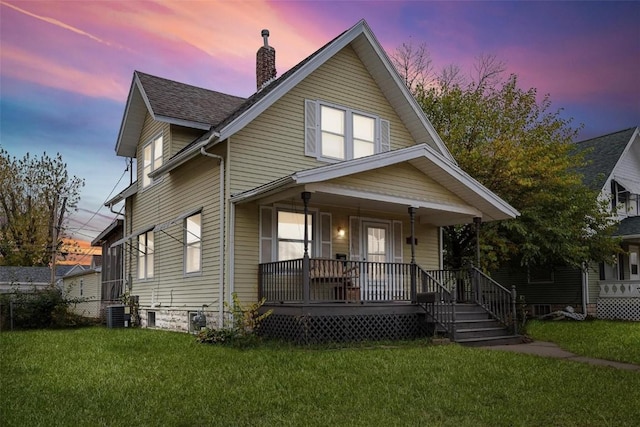 view of front of property featuring a yard and a porch