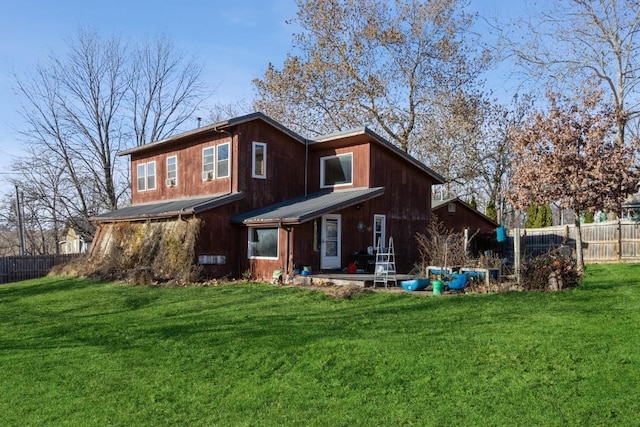 back of house featuring a patio and a lawn