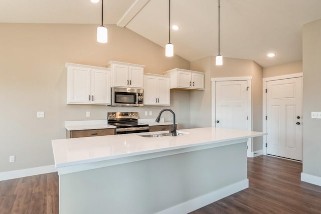 kitchen with an island with sink, white cabinetry, sink, hanging light fixtures, and stainless steel appliances