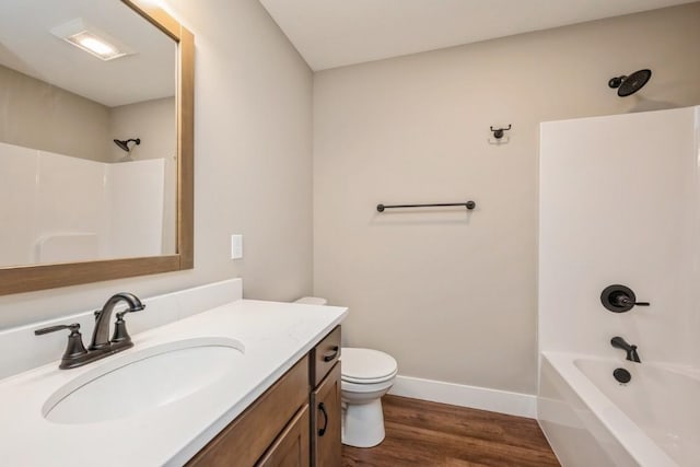 1807 Shady Grove Rd SW, Cedar Rapids, IA 52404 - full bathroom with toilet, vanity, wood finished floors, shower / bath combination, and baseboards