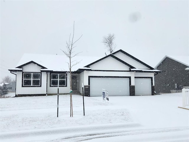 ranch-style home with board and batten siding and an attached garage