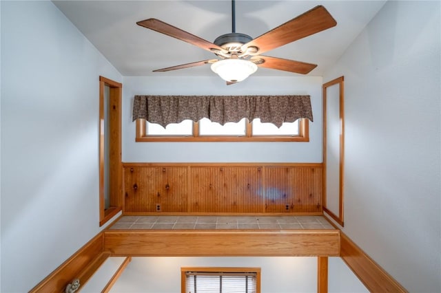 interior space with ceiling fan