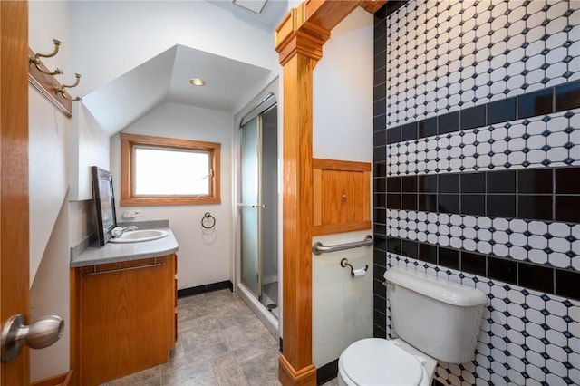 bathroom featuring vanity, a shower with shower door, toilet, and vaulted ceiling