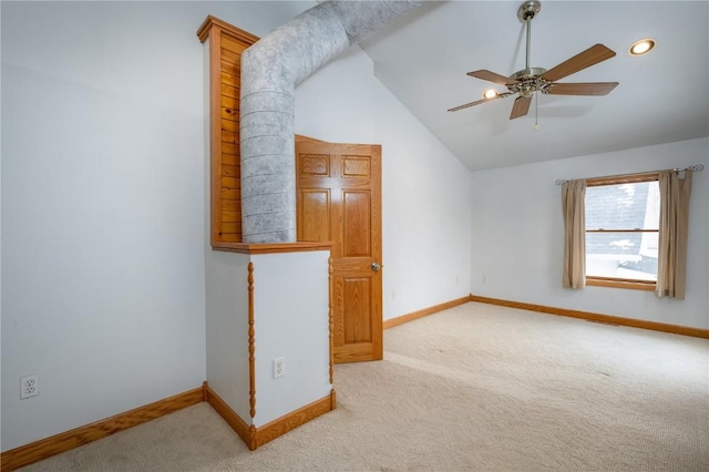 additional living space featuring lofted ceiling, light colored carpet, and ceiling fan