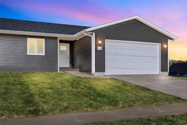 ranch-style house with a yard and a garage